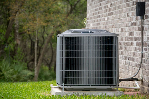 Outdoor AC unit next to a home.