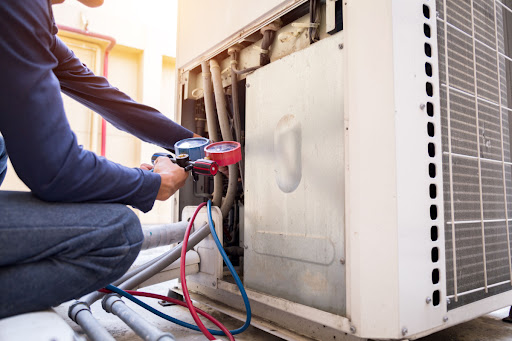 An HVAC technician inspecting a HVAC unit