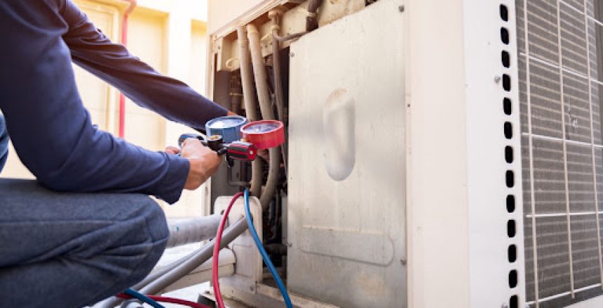 An HVAC technician inspecting a HVAC unit